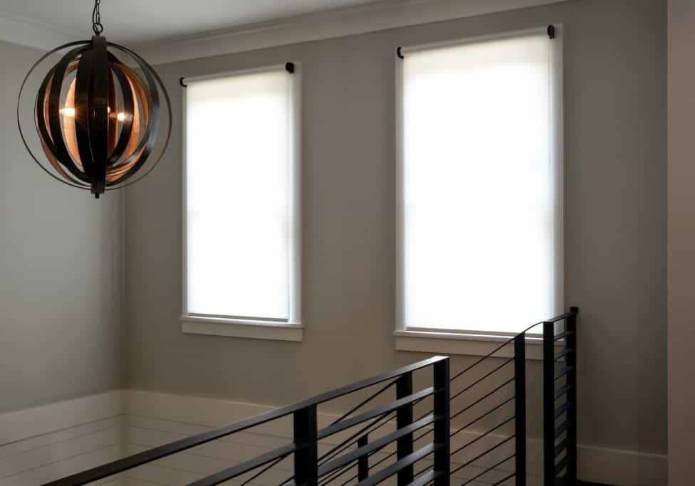 Harmonic Series Custom Automated Shades - windows inside covered by shades.